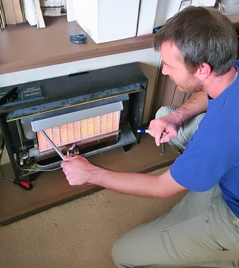 A radiator is being repaired by a Plumber